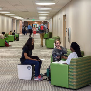 Students collaborating in hallway with flexible seating